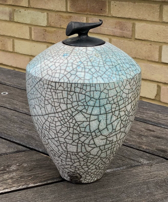 Tim Andrews (British, b.1960) raku pottery jar of curved conical form with horn-shaped finial. 